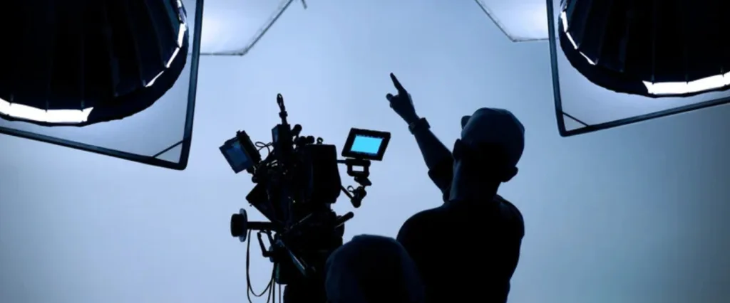 A man in a photo studio being in charge of the production process 