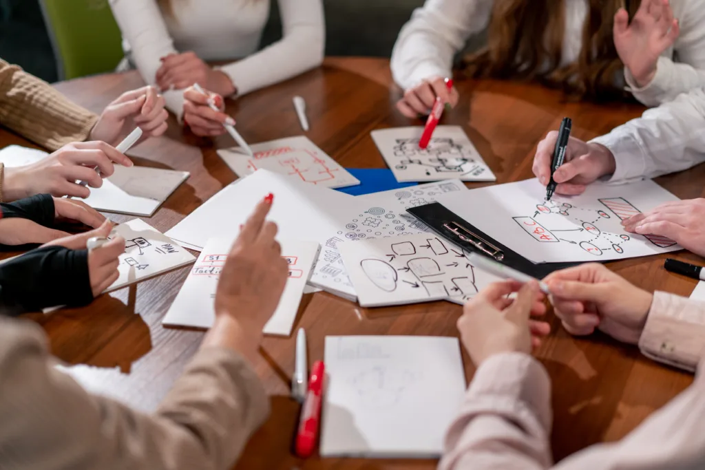 close-up of many diagrams and business plans written on sheets of paper during business meeting